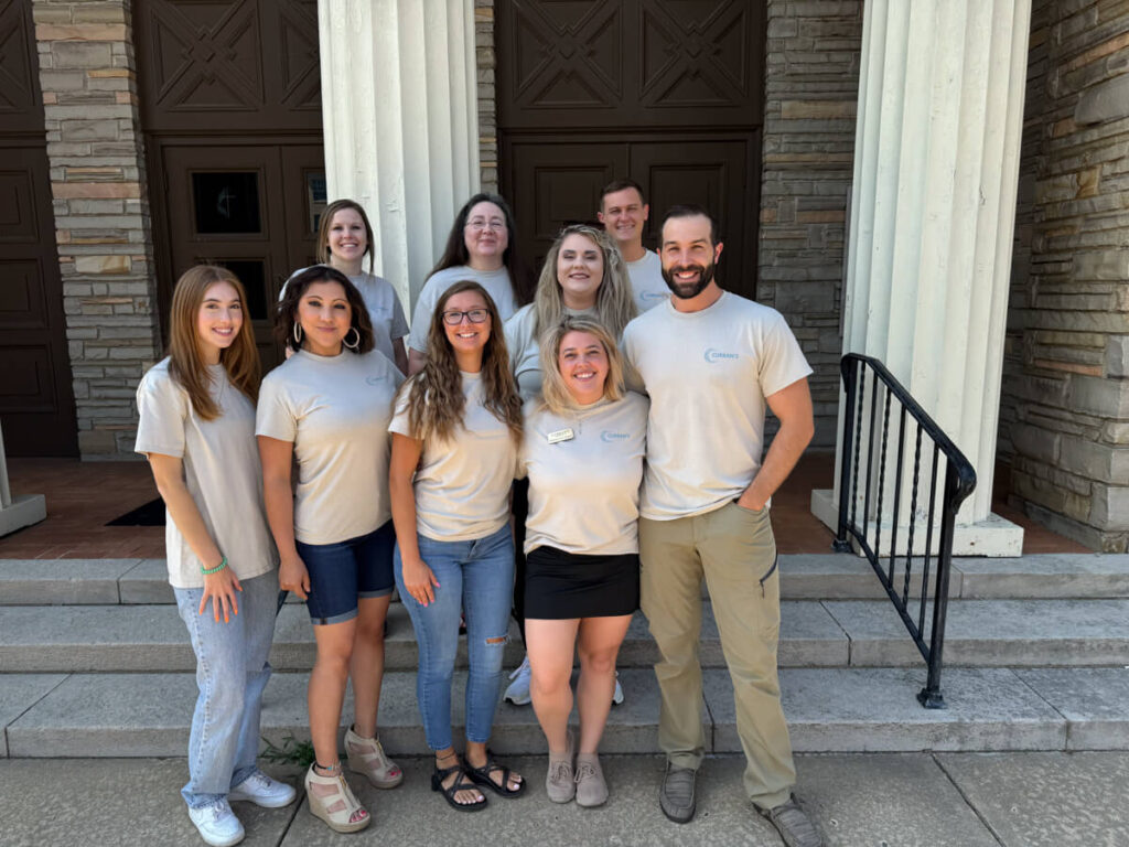 Group photo of staff with Curran's Title in Arkansas